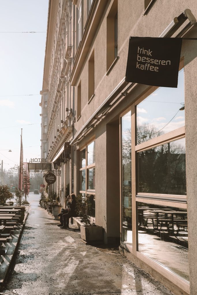 People sitting at a café window in Graz